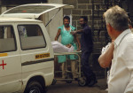 Hospital staff shifts a body of a person, killed in a bus rampage, into an ambulance in the city of Pune, central India, Wednesday, Jan. 25, 2012. A bus driver mowed down pedestrians and rammed cars, scooters and food stalls in a rampage through crowded Indian streets Wednesday. (AP Photo)